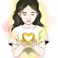 a girl holding a gold heart in her hands